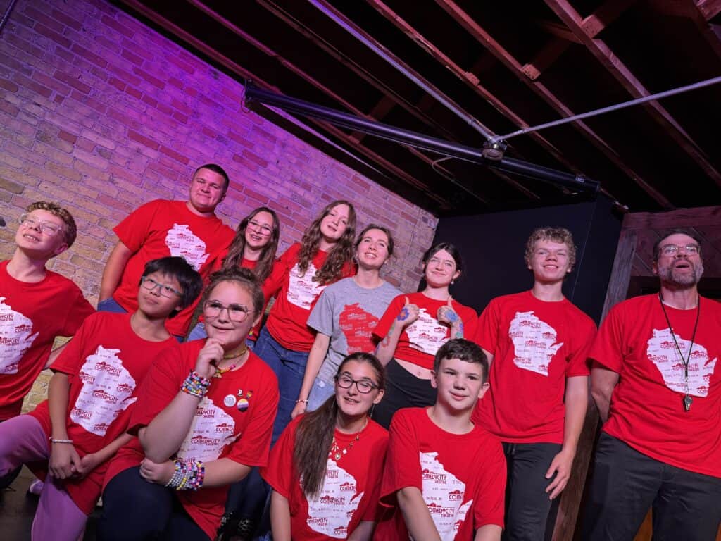group shot of kids on stage performing improv